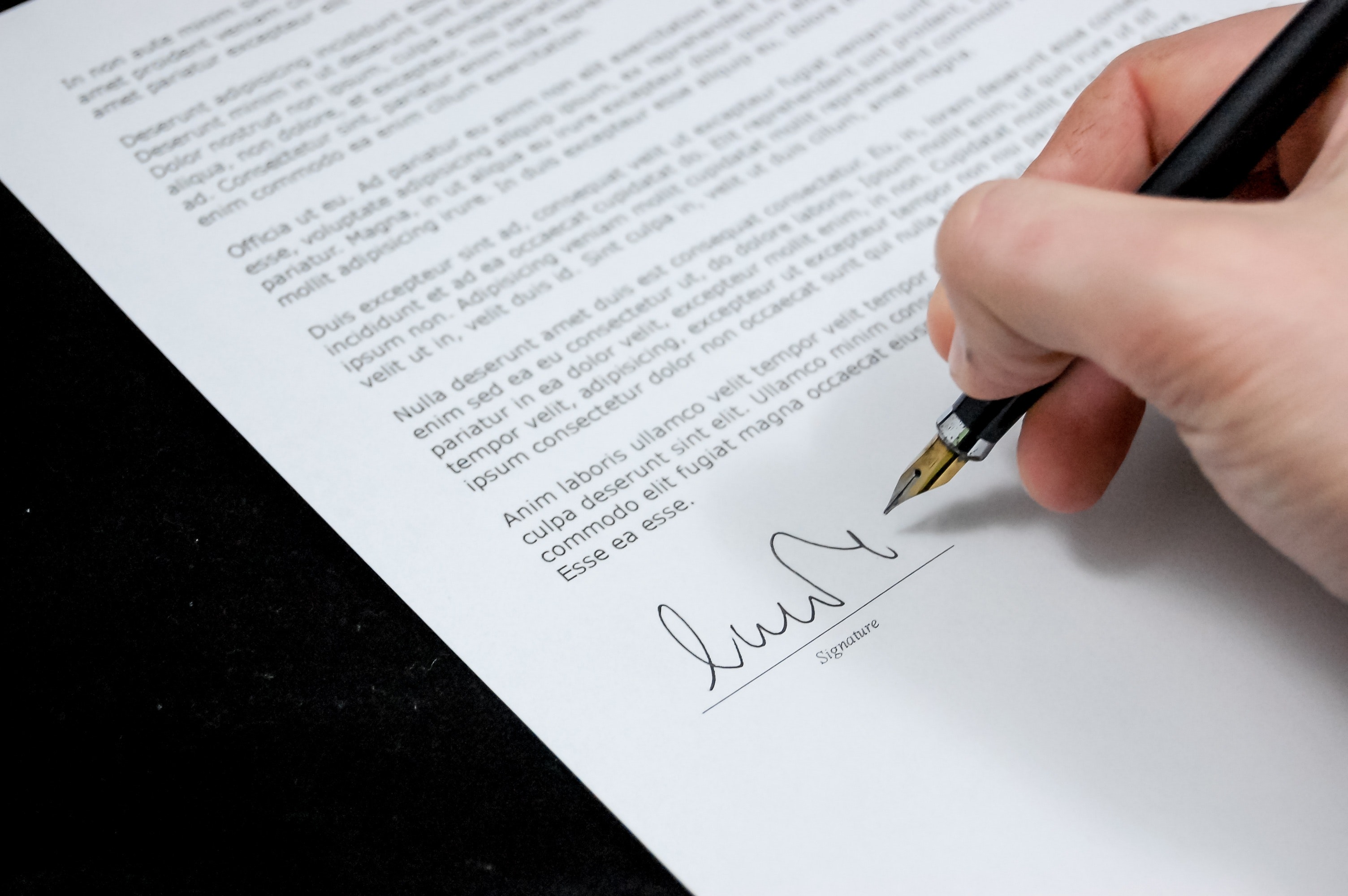 Close up of person signing a contract Close up of person signing a contract